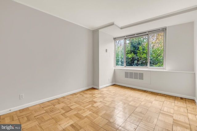 empty room featuring crown molding and light parquet floors