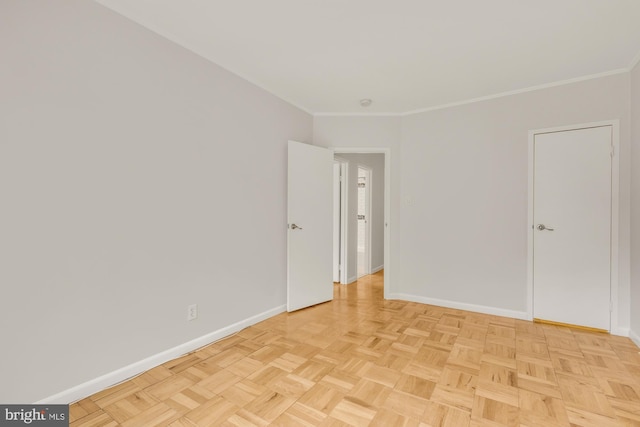 spare room featuring light parquet floors and crown molding