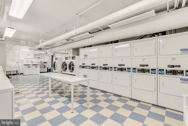 laundry area featuring washer and clothes dryer and stacked washing maching and dryer