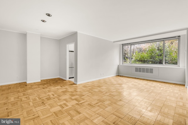 unfurnished room featuring ornamental molding and light parquet floors