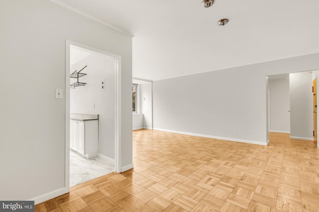 spare room featuring crown molding and light parquet flooring