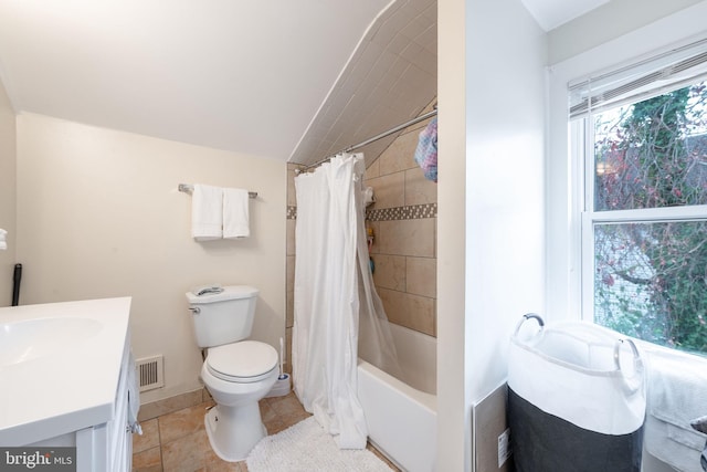 full bathroom featuring tile patterned flooring, vanity, toilet, and shower / bath combo with shower curtain