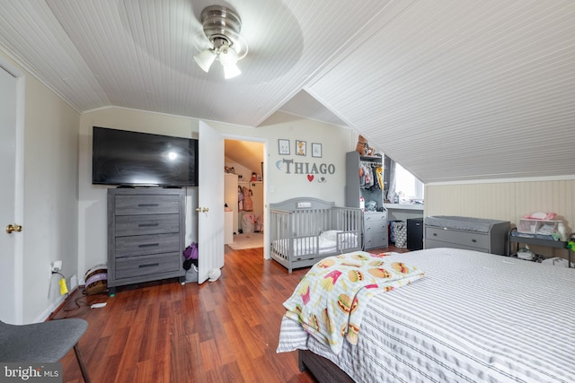 bedroom with ceiling fan, dark wood-type flooring, vaulted ceiling, and ornamental molding