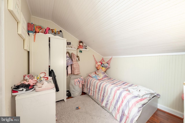 bedroom with light wood-type flooring and vaulted ceiling