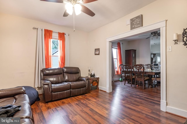 living room featuring dark hardwood / wood-style floors and ceiling fan