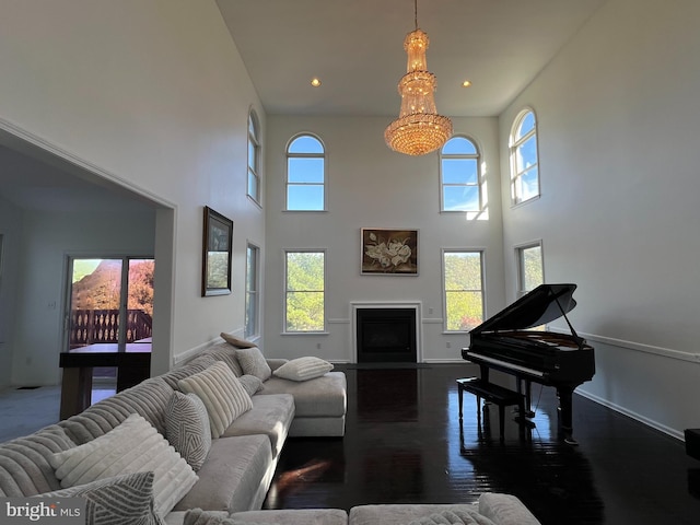 living room with hardwood / wood-style floors and a towering ceiling