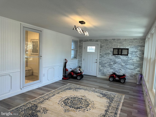 entryway featuring hardwood / wood-style floors and a textured ceiling