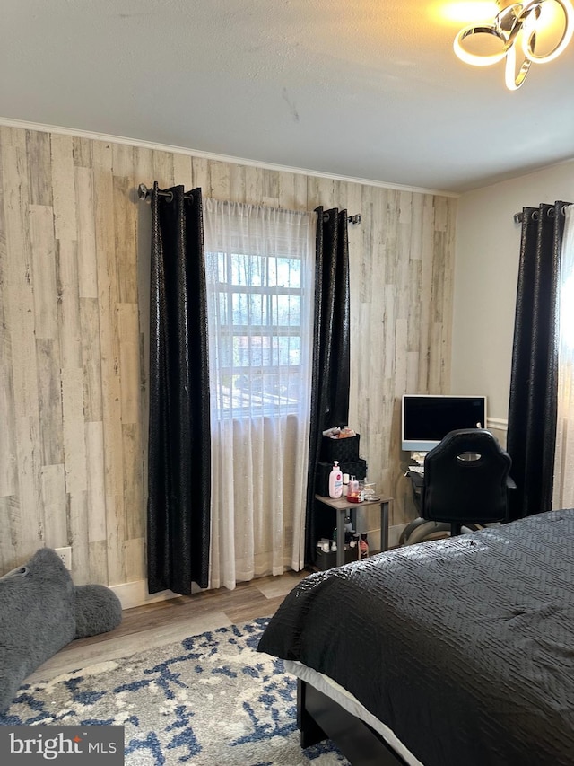 bedroom featuring wooden walls and wood-type flooring