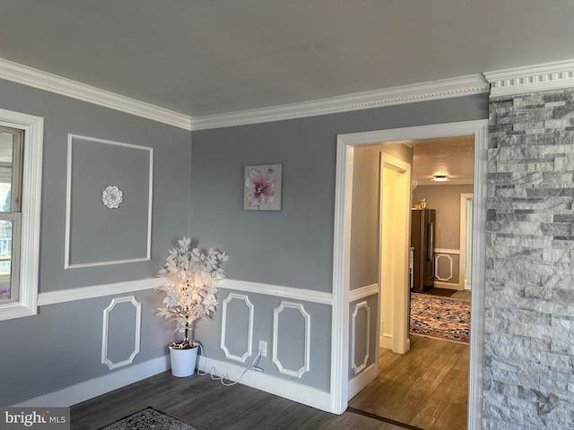 interior space with dark hardwood / wood-style flooring and ornamental molding