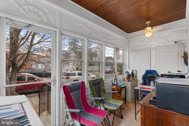 sunroom / solarium with ceiling fan and wood ceiling