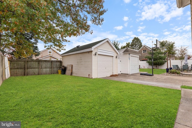 view of yard featuring an outbuilding and a garage