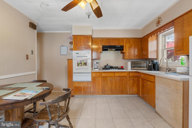 kitchen featuring ornamental molding, stainless steel appliances, and light tile patterned floors