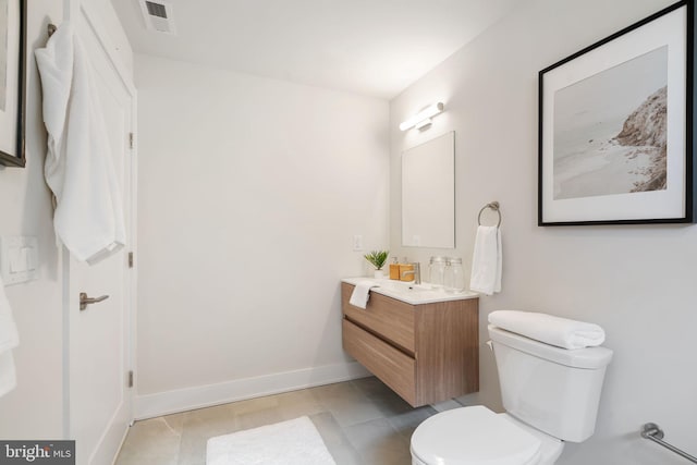 bathroom with tile patterned flooring, vanity, and toilet