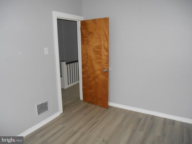 spare room with wood-type flooring