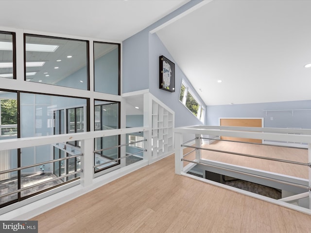 interior space with hardwood / wood-style floors and high vaulted ceiling