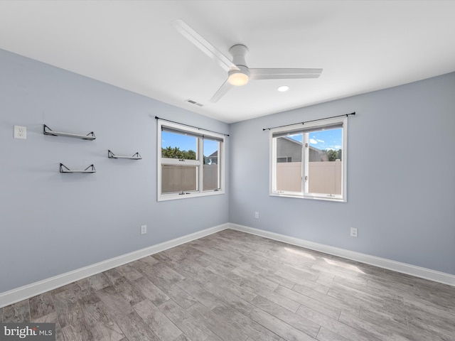 empty room featuring wood-type flooring and ceiling fan