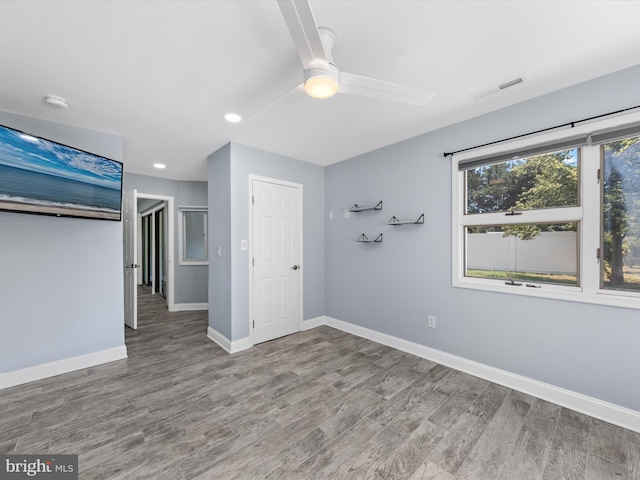 unfurnished bedroom featuring hardwood / wood-style floors and ceiling fan