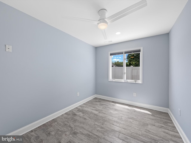 unfurnished room with hardwood / wood-style flooring and ceiling fan