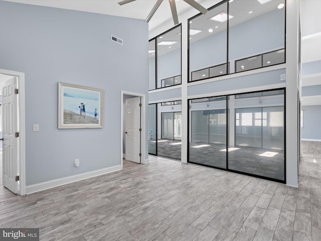 interior space featuring light hardwood / wood-style floors and a high ceiling