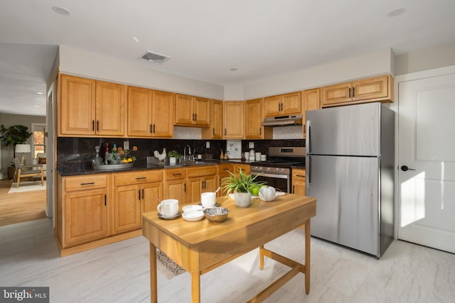 kitchen with stainless steel appliances, tasteful backsplash, and sink