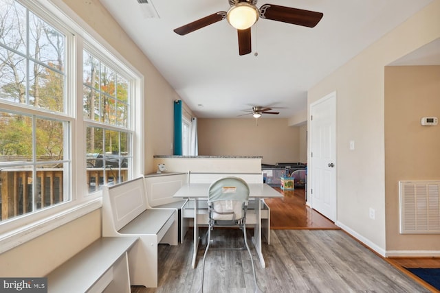 dining room with ceiling fan and hardwood / wood-style floors