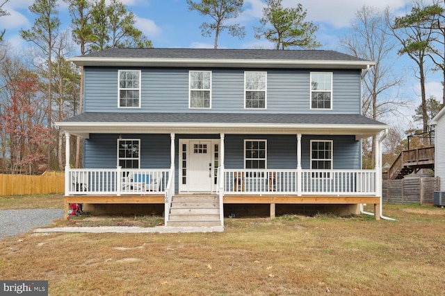 view of front facade featuring a front lawn and central AC