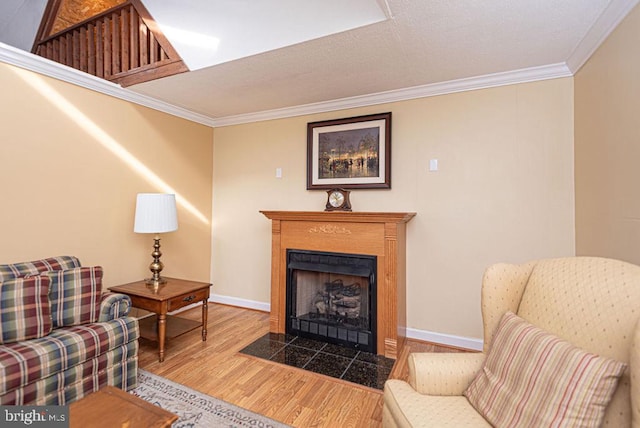 living area featuring hardwood / wood-style floors and ornamental molding