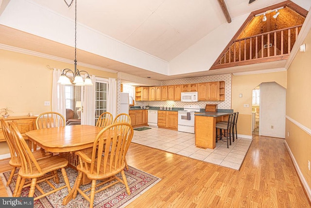 dining space with light hardwood / wood-style flooring, beamed ceiling, high vaulted ceiling, a notable chandelier, and ornamental molding