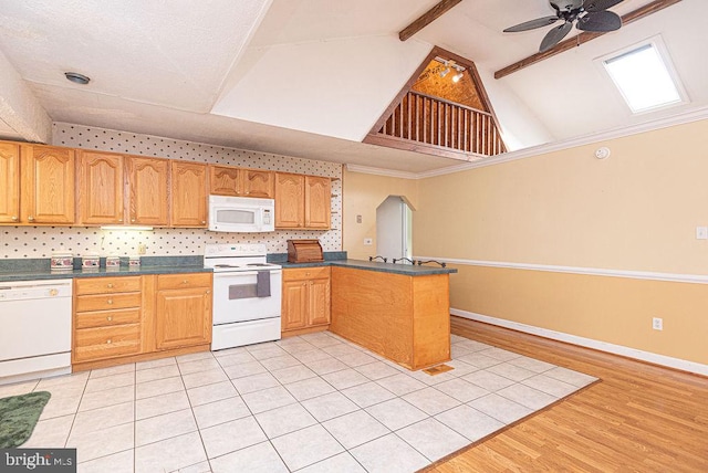 kitchen with white appliances, vaulted ceiling with beams, ceiling fan, light wood-type flooring, and kitchen peninsula