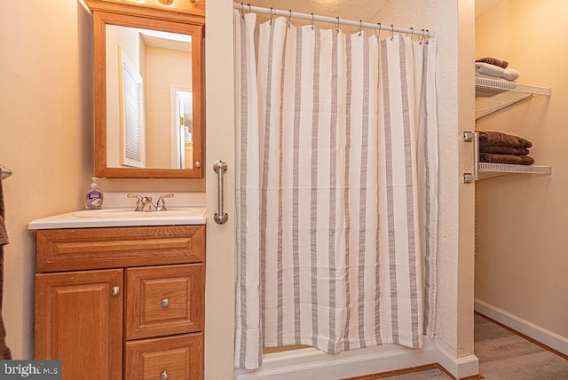 bathroom with vanity and wood-type flooring