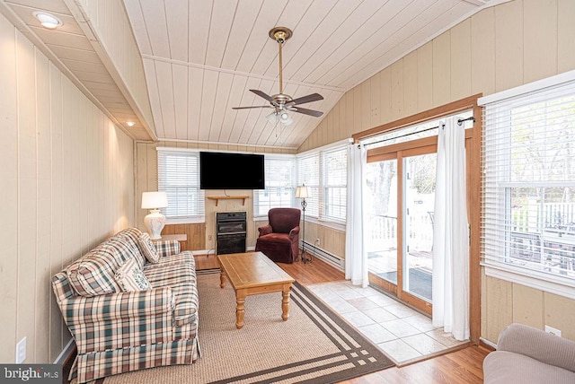 sunroom / solarium with a wealth of natural light, lofted ceiling, and wood ceiling