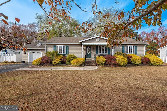 single story home featuring a garage and a front lawn