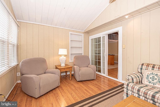 living area featuring wood walls, wood-type flooring, wood ceiling, and vaulted ceiling