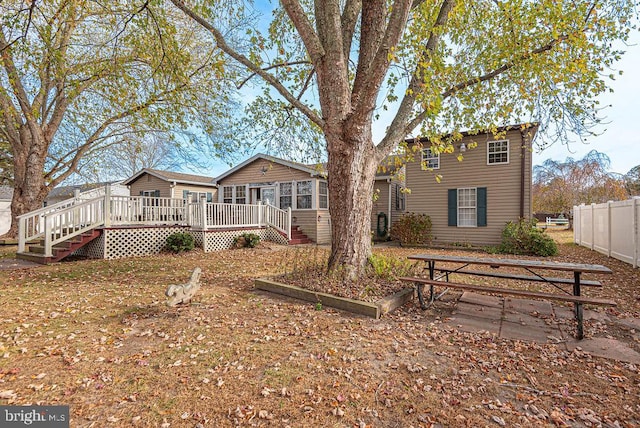 view of front facade with a wooden deck