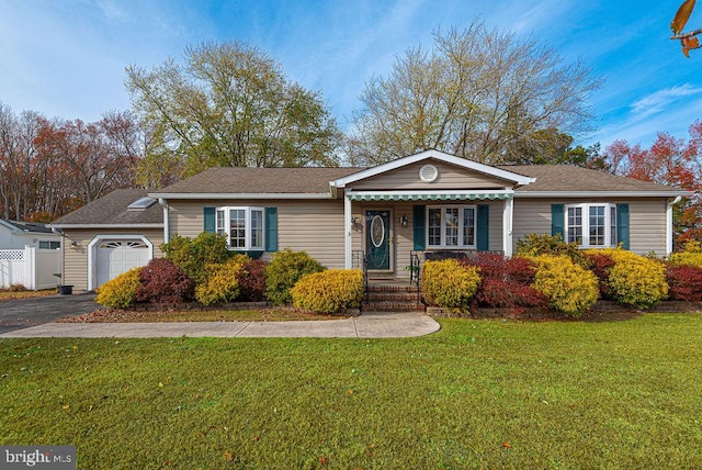 ranch-style home featuring a garage and a front yard