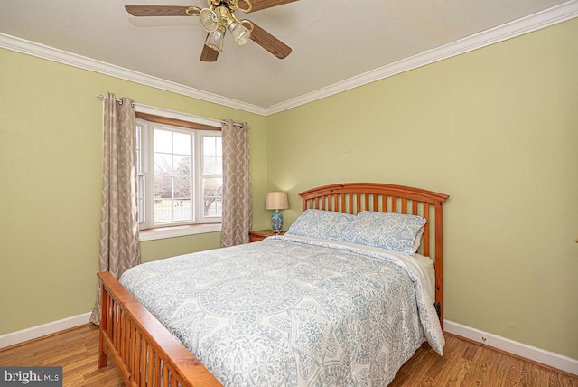 bedroom with ceiling fan, wood-type flooring, and ornamental molding