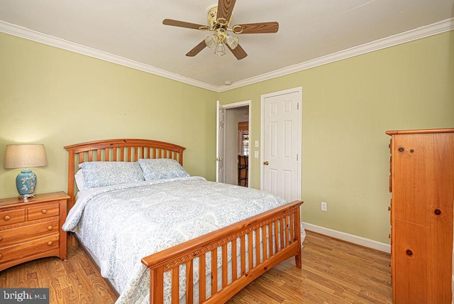 bedroom featuring ceiling fan, light hardwood / wood-style floors, and ornamental molding