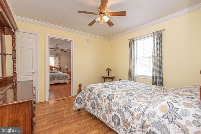 bedroom with ceiling fan, light hardwood / wood-style floors, and ornamental molding