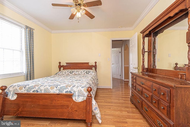 bedroom featuring light hardwood / wood-style floors, ceiling fan, and ornamental molding