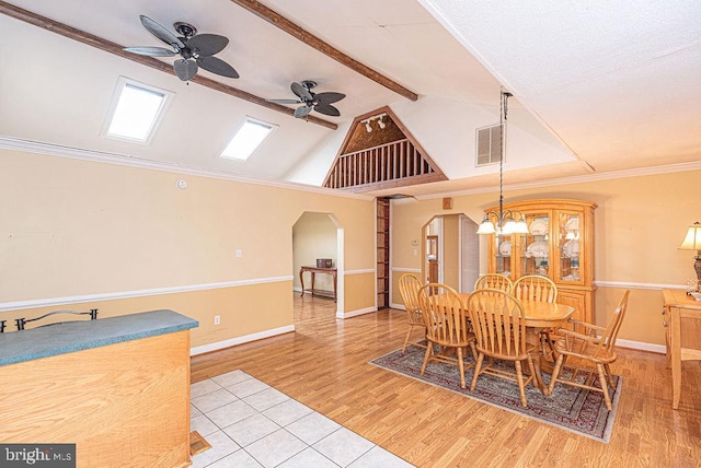 dining room with light hardwood / wood-style flooring, beamed ceiling, high vaulted ceiling, crown molding, and ceiling fan with notable chandelier