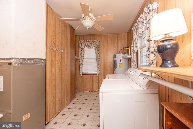 washroom featuring electric water heater, ceiling fan, crown molding, wooden walls, and washer and dryer