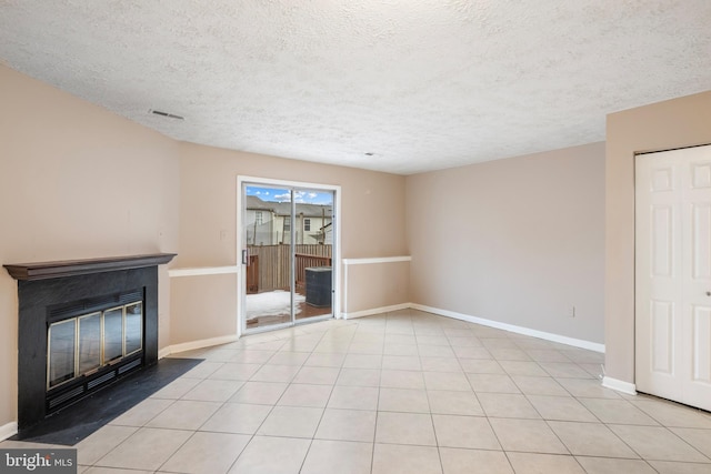 unfurnished living room with light tile patterned floors and a textured ceiling