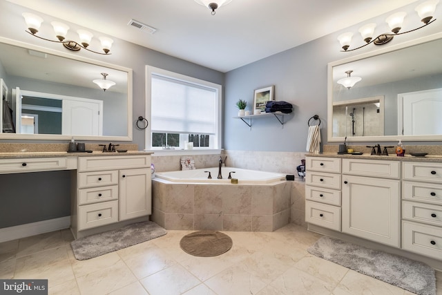 full bath featuring a bath, a sink, two vanities, and visible vents