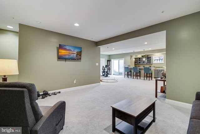 living room featuring recessed lighting, light colored carpet, and baseboards