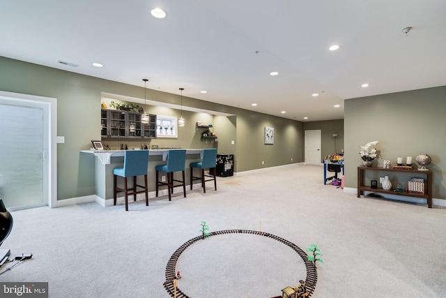 interior space featuring light carpet, visible vents, decorative light fixtures, light countertops, and recessed lighting