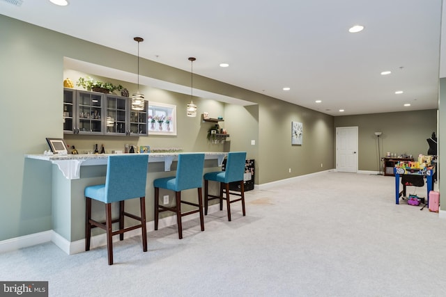 bar with decorative light fixtures, recessed lighting, light colored carpet, bar, and baseboards