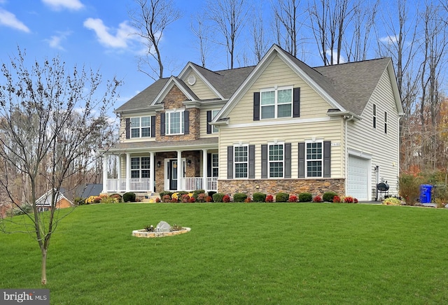 craftsman house featuring a garage, covered porch, stone siding, and a front lawn