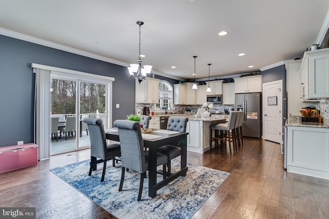 dining room with dark wood-style floors, ornamental molding, and recessed lighting