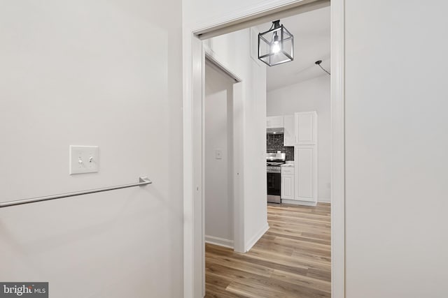 hallway with light hardwood / wood-style floors