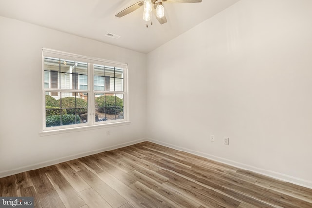 unfurnished room featuring ceiling fan, wood-type flooring, and vaulted ceiling